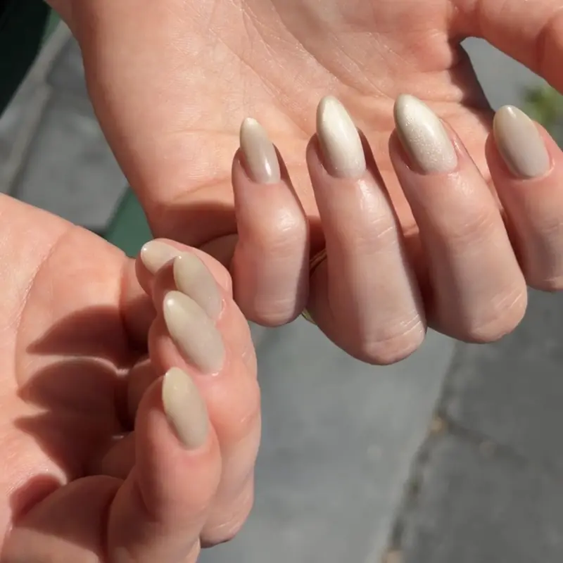 Long almond nails in a sheer nude gel with close, clean cuticles